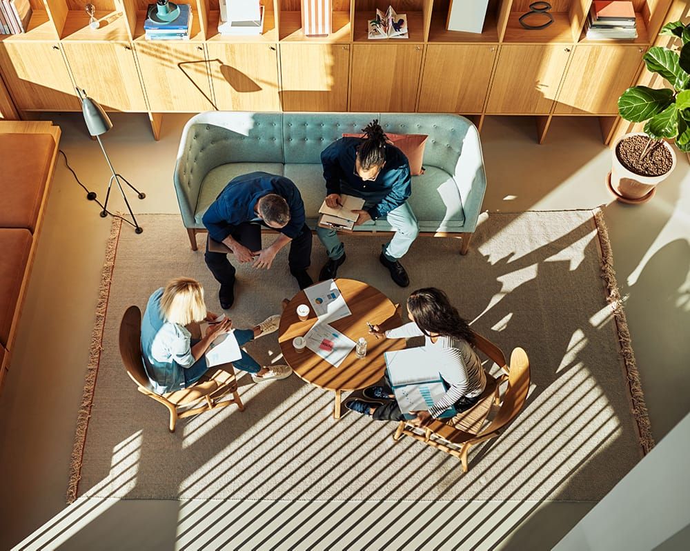 A birds eye view of a  team of multiethnic physicians having professional conversations.