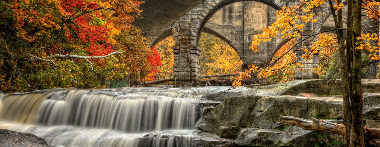 A waterfall surrounded by trees with colorful leaves in Ohio.