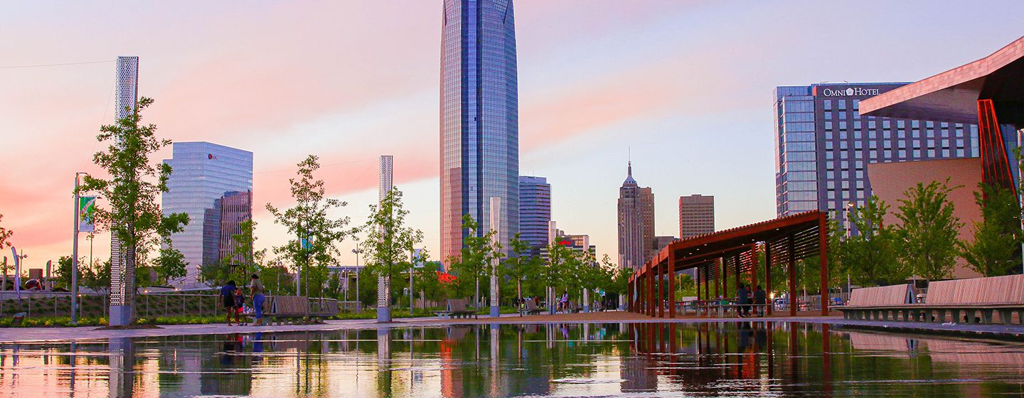 Downtown city with tall buildings and river in the foreground in Oklahoma.
