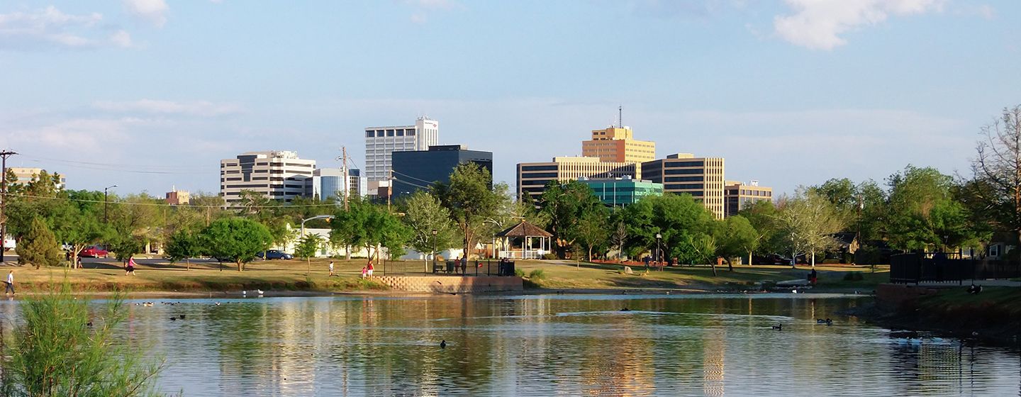 Downtown cityscape view with a calm river in the foreground in Texas.